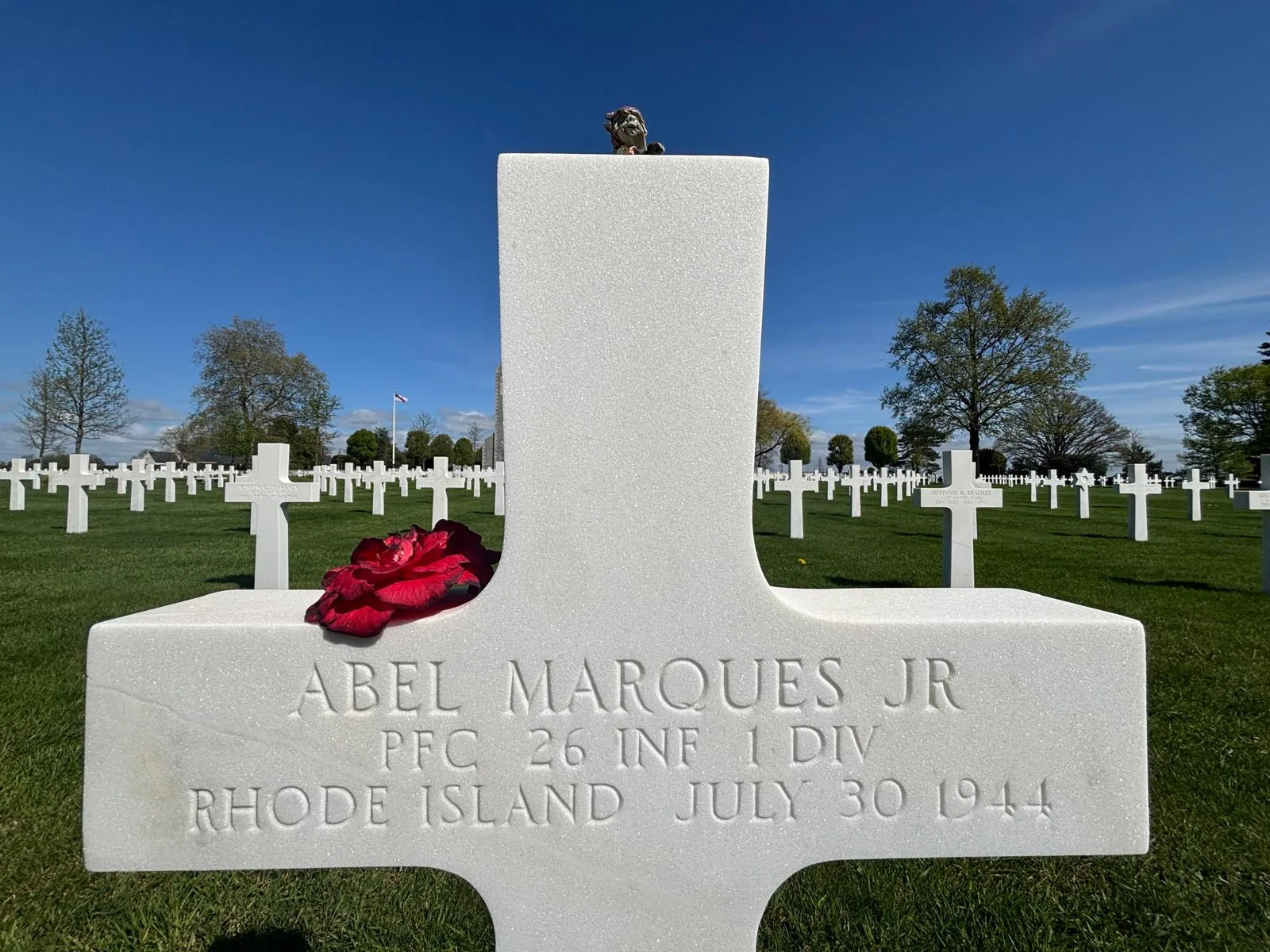 Abel Marques Jr's cross with a red rose placed against the white marble