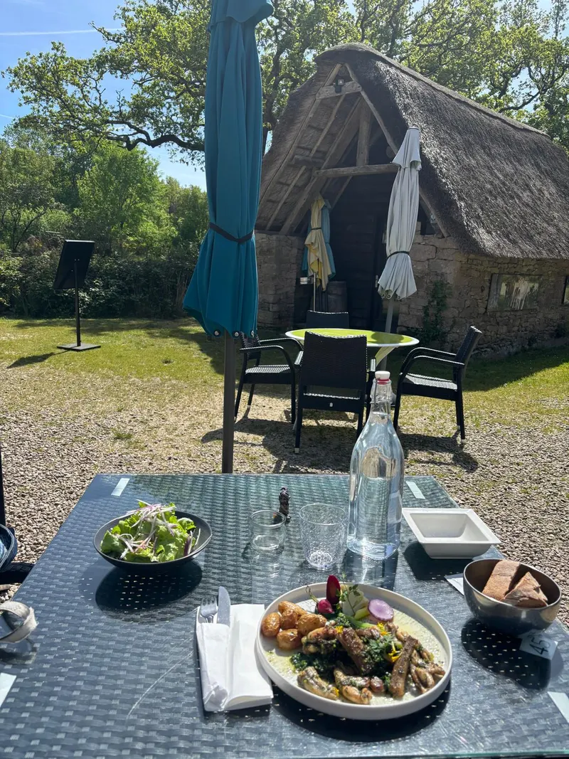 Lunch on the terrace at the Auberge de Kerhinet with thatched rooftops behind