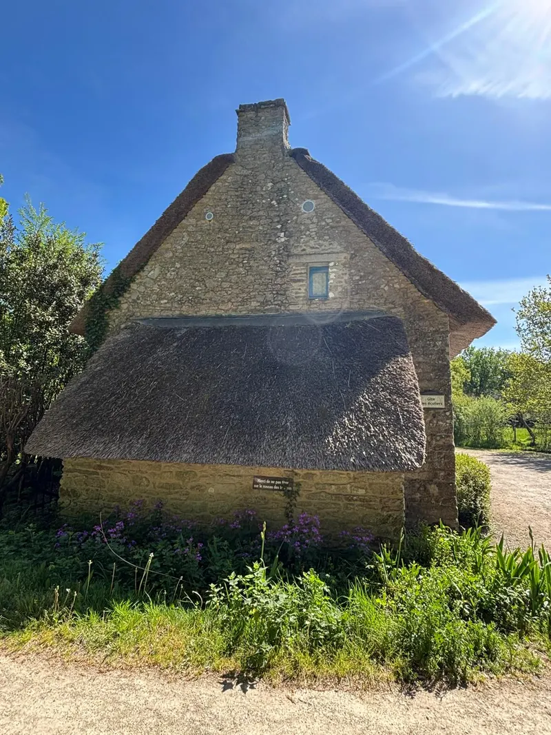 Traditional stone cottage with reed thatch roof in the Briere