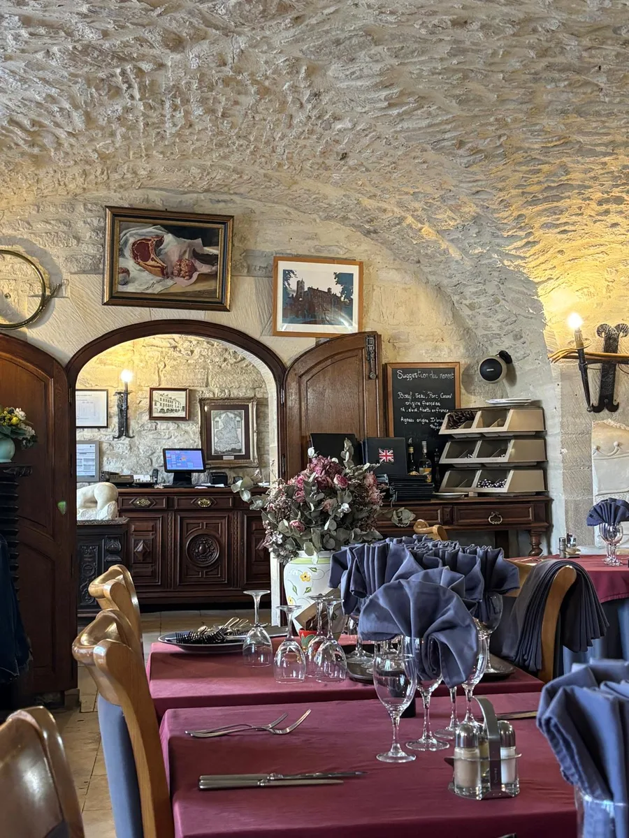 The main dining room with paintings, reception desk and chalkboard menu