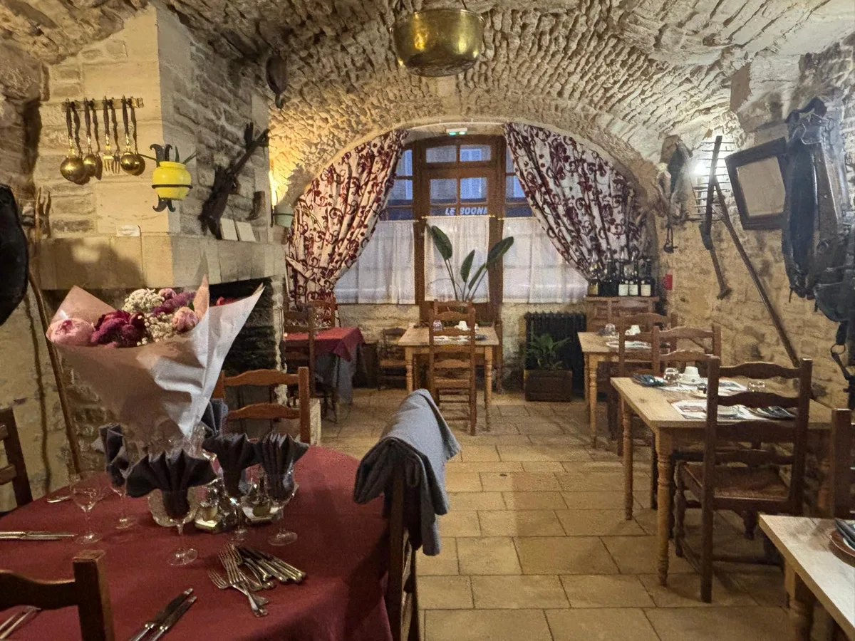 The rustic dining room in the evening, copper pots and fireplace
