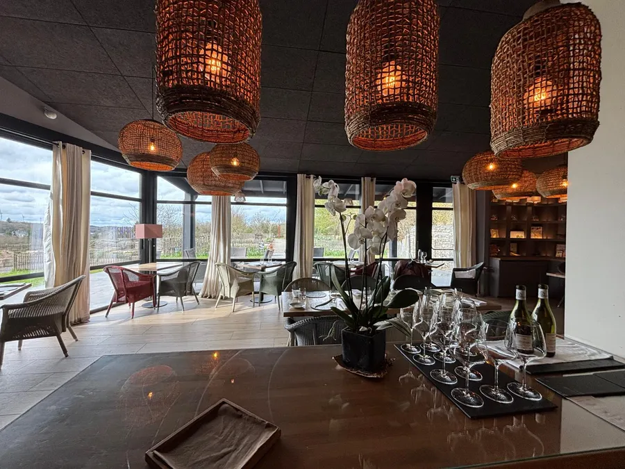 Elegant bar area with rattan pendant lights and white orchid