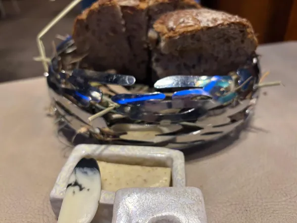 Sourdough bread in a handcrafted metal nest basket