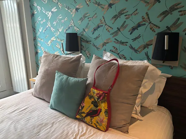 Hotel room with turquoise bird wallpaper